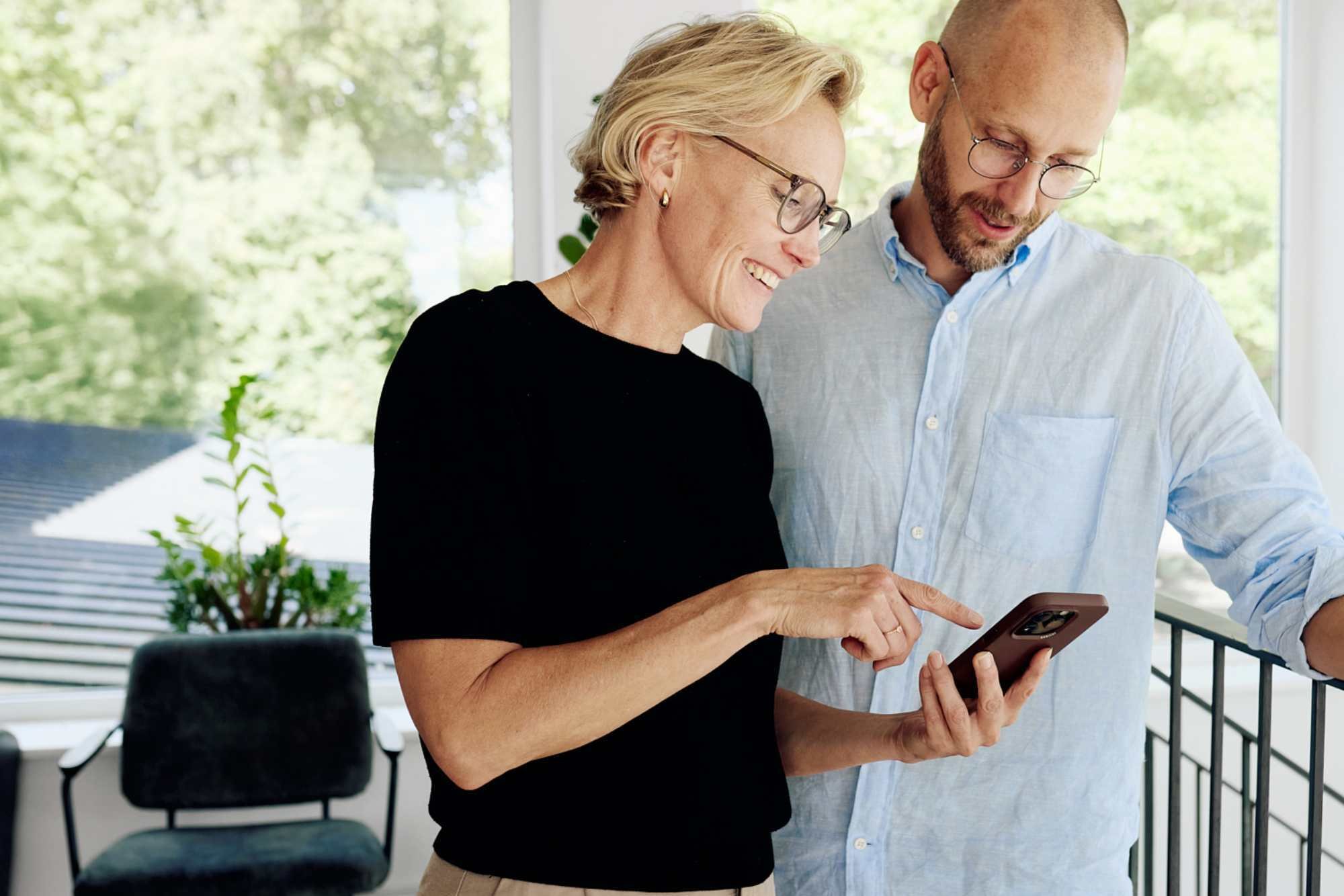 two colleagues looking at mobile